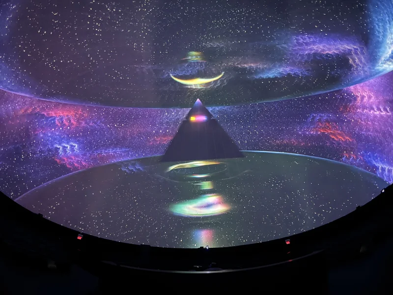 Dome theatre displaying colorful Pink Floyd projected art.