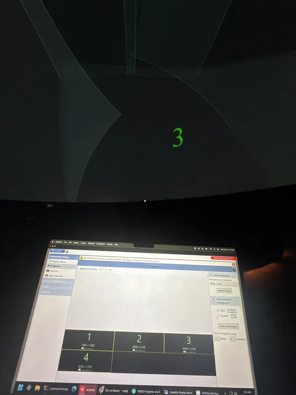 Laptop and Dome screen showing projector field calibration.