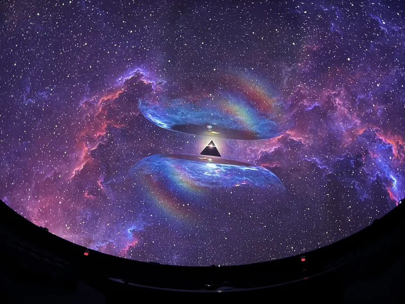 Dome theatre displaying colorful Pink Floyd projected art.