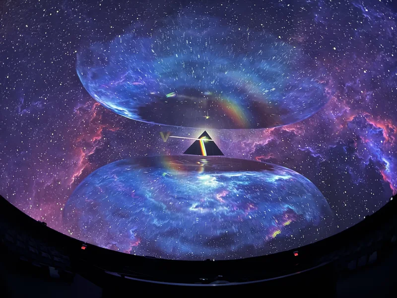 Dome theatre displaying colorful Pink Floyd projected art.