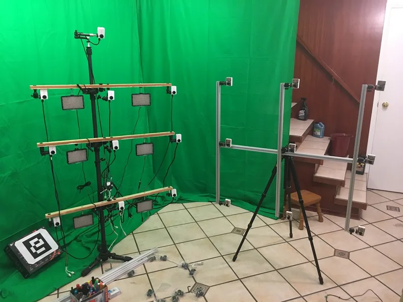 Linear multi-camera array in front of green screen.