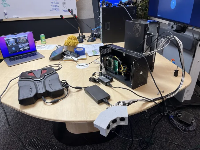 Mobile Portrait prototype with cameras, portable computing and power hardware in a meeting room.