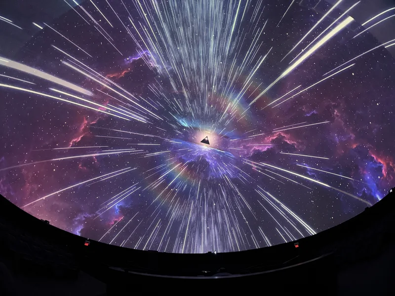 Dome theatre displaying colorful Pink Floyd projected art.