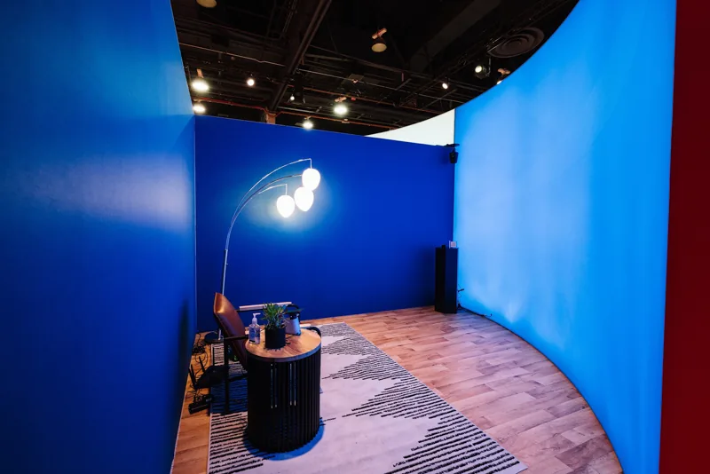 Kokomo immersive-call demonstration space with blue walls, chair and table, Canon booth, CES 2022.