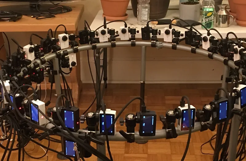 Empty circular head capture array with multiple cameras and lighting.