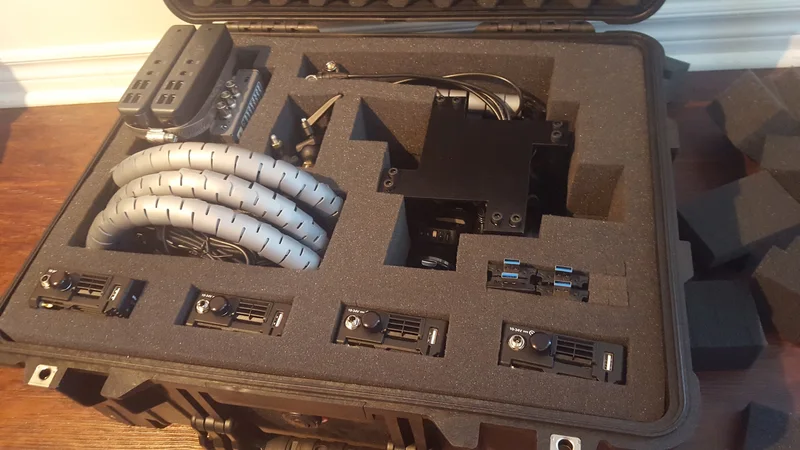 Camera modules and shaped padding packed into a case.