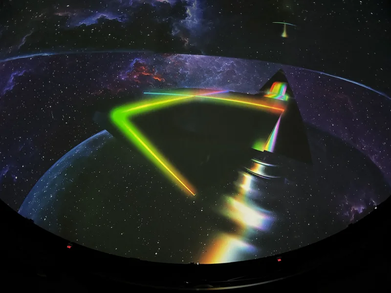 Dome theatre displaying colorful Pink Floyd projected art.