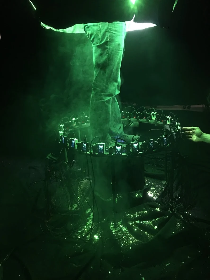 Bullet-time camera ring around tree trunk in green light.