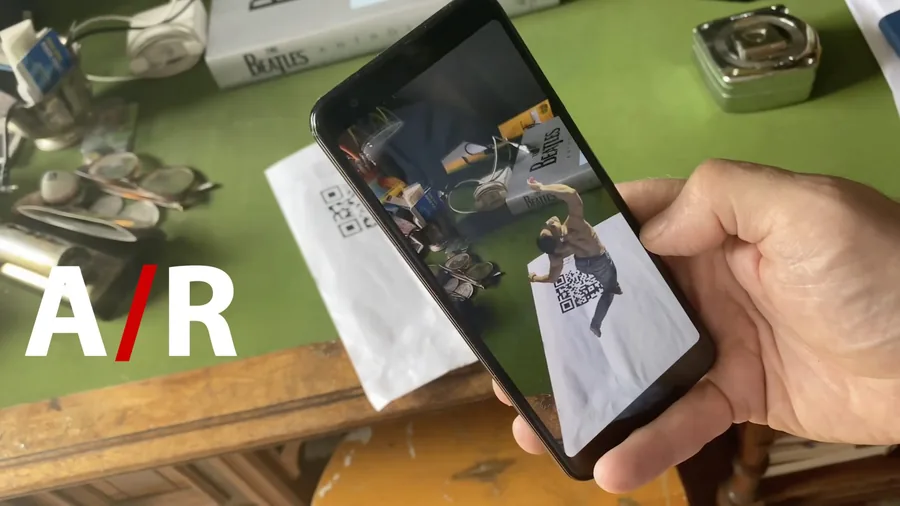 The captured performance playing in augmented reality on a phone above a QR target.