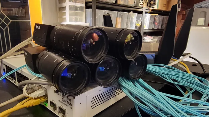 Five-camera MultiView prototype with Ethernet cabling and network switch.