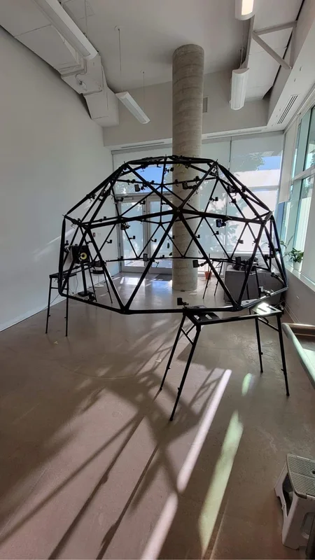 Portrait view of a geodesic multi-camera dome installed in a studio.