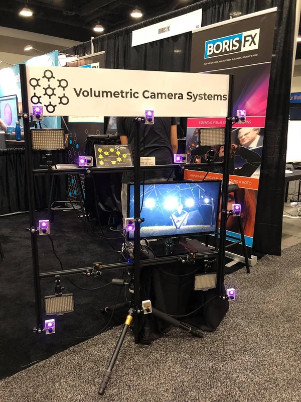 Portrait of the VCS camera array and booth, with monitor and tripod.