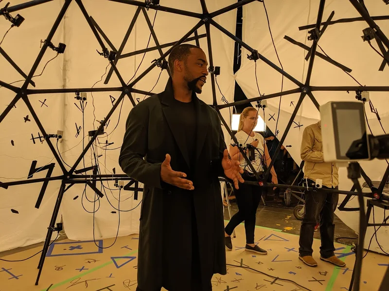Performer standing inside studio dome capture rig.