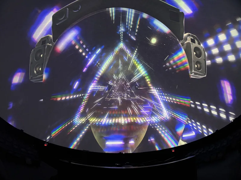 Dome theatre displaying colorful Pink Floyd projected art.