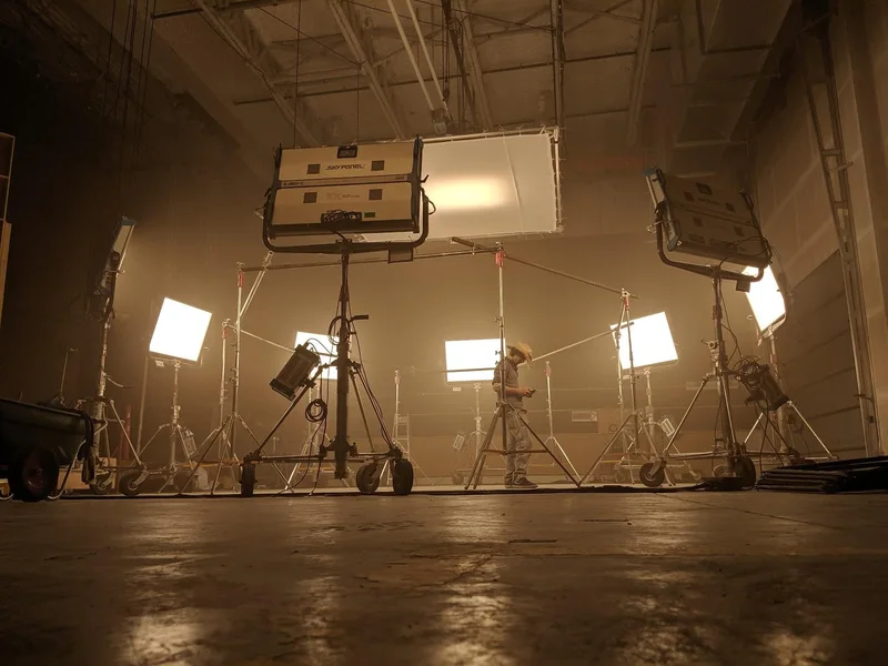 Warm-lit studio capture setup photographed from floor level.